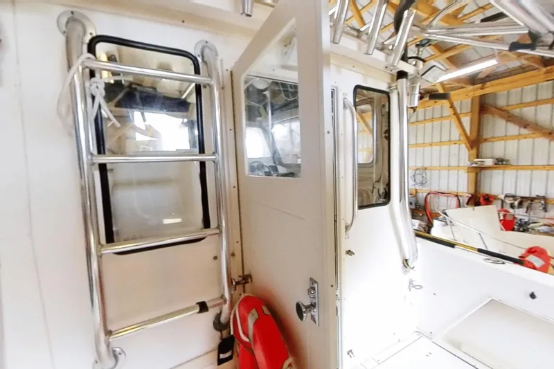  Yacht Photos Pics Interior view of 2009 McKee Craft 28 boat with ladder and open door.