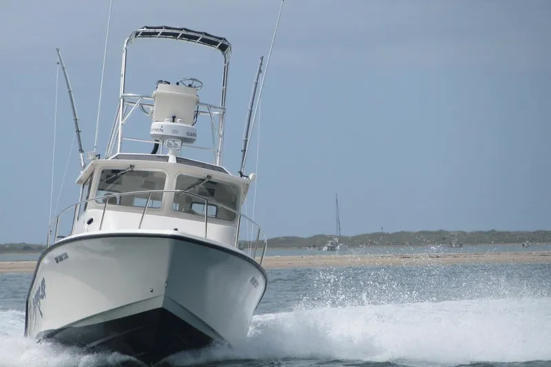  Yacht Photos Pics 2009 McKee Craft 28 boat cruising on open water with a clear sky backdrop.