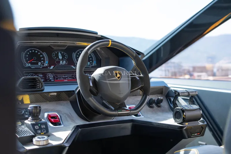 Fast Toy Yacht Photos Pics Cockpit of 2023 Tecnomar for Lamborghini 63 yacht, featuring sleek steering and digital dashboard.