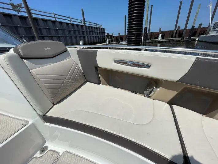 Black Pearl Yacht Photos Pics 2018 Chaparral 337 SSX boat interior seating at a marina.