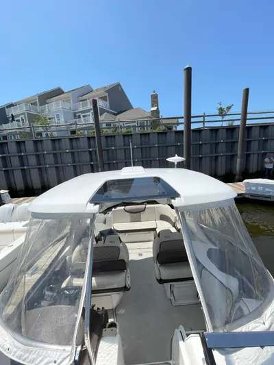 Black Pearl Yacht Photos Pics 2018 Chaparral 337 SSX boat docked with clear canopy and seating area.