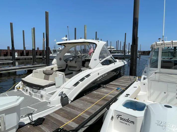 Black Pearl Yacht Photos Pics 2018 Chaparral 337 SSX luxury boat docked at marina on a sunny day.