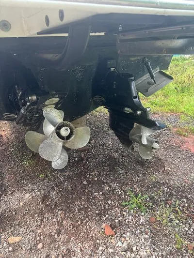  Yacht Photos Pics Propellers of a 2019 Sea Ray 350 Sundancer Coupe on gravel surface.