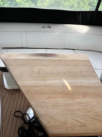  Yacht Photos Pics 2019 Sea Ray 350 Sundancer Coupe interior with wooden table and seating.