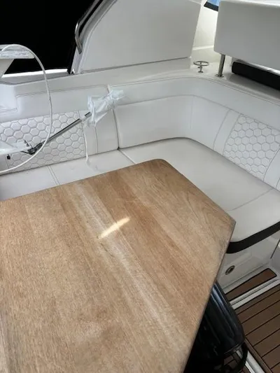 Yacht Photos Pics 2019 Sea Ray 350 Sundancer Coupe interior with white seating and wooden table.