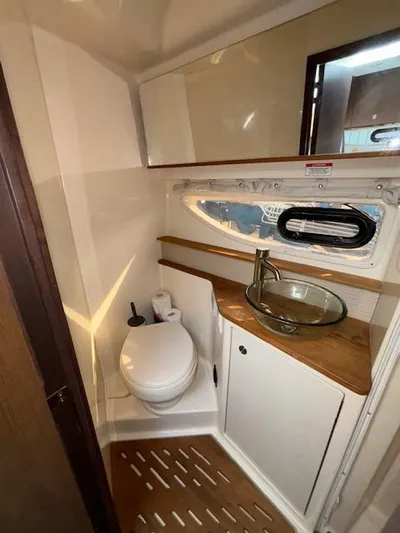  Yacht Photos Pics 2019 Sea Ray 350 Sundancer Coupe bathroom with modern fixtures and wooden accents.