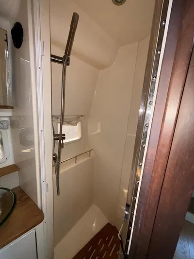  Yacht Photos Pics 2019 Sea Ray 350 Sundancer Coupe shower area with modern fixtures and wooden accents.