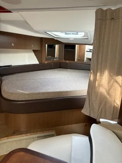 Yacht Photos Pics Interior cabin of 2019 Sea Ray 350 Sundancer Coupe with bed and seating area.