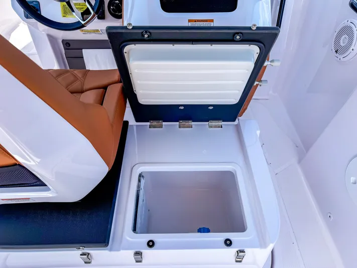  Yacht Photos Pics 2025 Axopar 25 Cross Top boat interior with open storage compartment and brown seating.