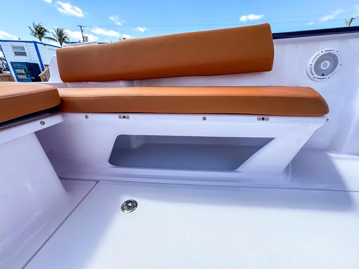  Yacht Photos Pics 2025 Axopar 25 Cross Top boat interior with tan seating and storage compartment.