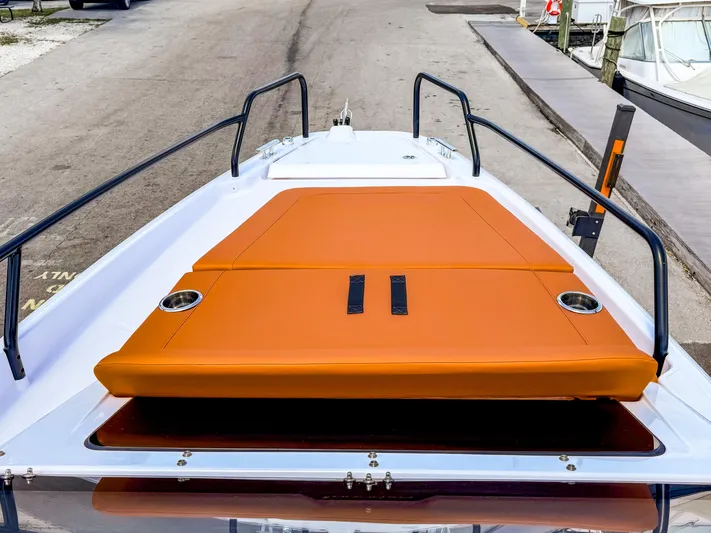  Yacht Photos Pics 2025 Axopar 25 Cross Top boat with orange deck seating, docked at marina.