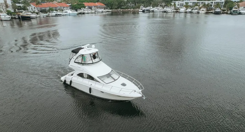  Yacht Photos Pics 2010 Sea Ray 390 Sedan Bridge yacht cruising in a marina.