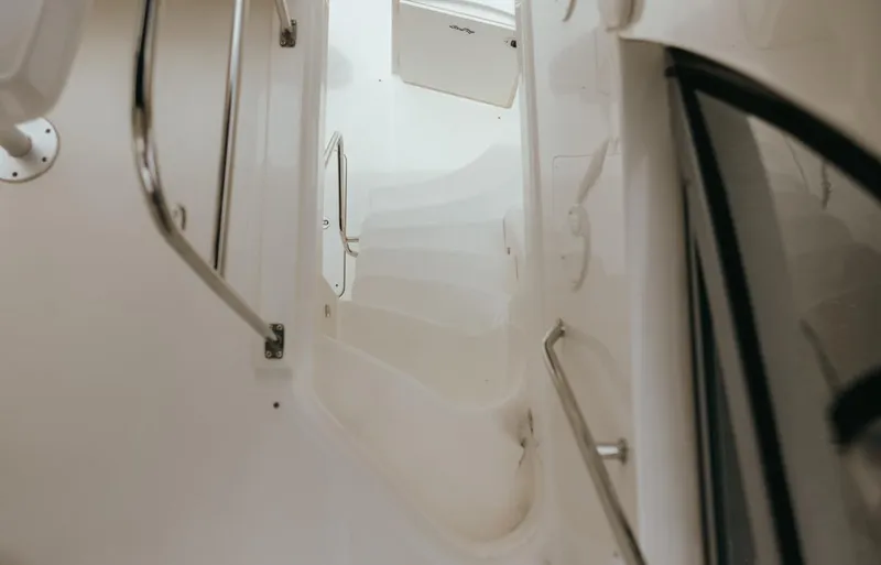  Yacht Photos Pics Staircase on 2010 Sea Ray 390 Sedan Bridge yacht, featuring sleek white design and metal railings.