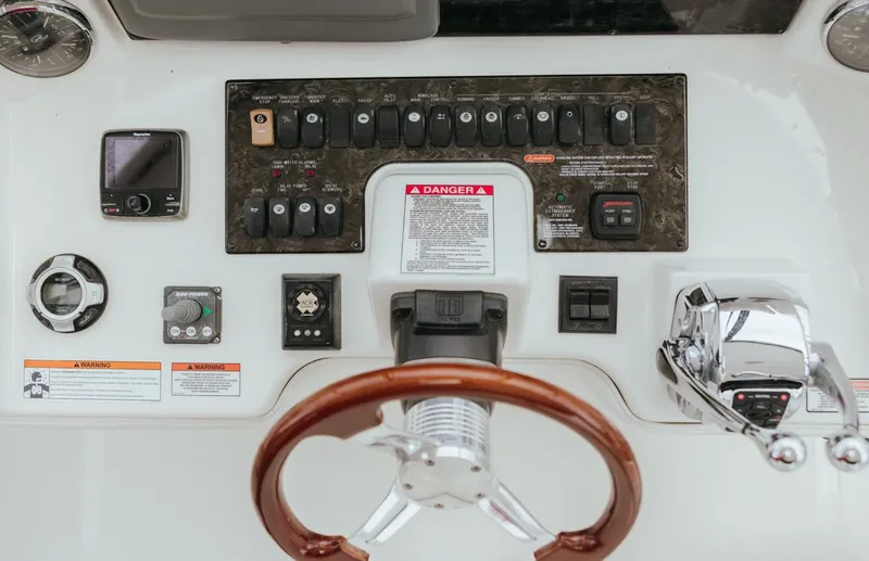  Yacht Photos Pics Control panel of a 2010 Sea Ray 390 Sedan Bridge with steering wheel and switches.