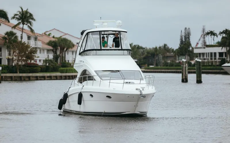 Yacht Photos Pics 2010 Sea Ray 390 Sedan Bridge yacht cruising on a calm waterway.