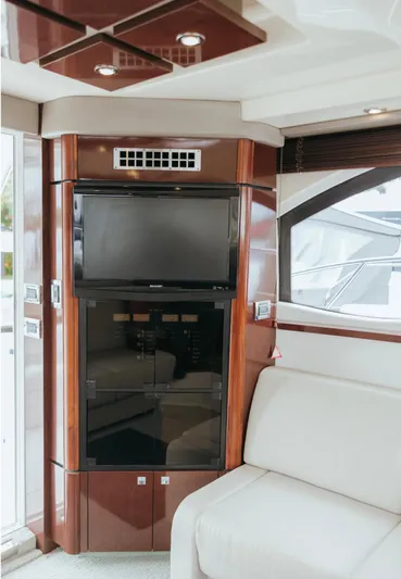  Yacht Photos Pics Luxurious interior of 2010 Sea Ray 390 Sedan Bridge with TV and elegant wood finish.
