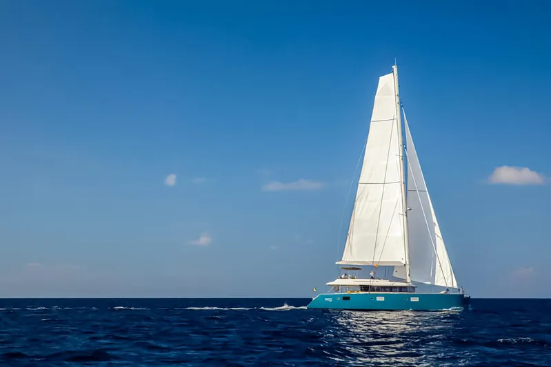Firefly Yacht Photos Pics Sailing yacht Lagoon 620 NEO 2012 on open sea under clear blue sky.