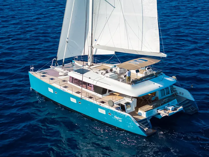 Firefly Yacht Photos Pics Lagoon 620 NEO 2012 catamaran sailing on open blue sea with white sails.