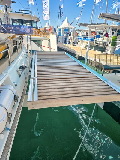 Firefly Yacht Photos Pics Lagoon 620 NEO 2012 yacht with wooden gangway at marina.