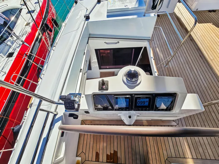 Firefly Yacht Photos Pics Lagoon 620 NEO 2012 yacht cockpit with navigation instruments and teak decking.