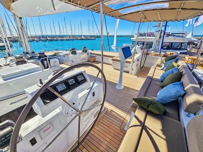 Firefly Yacht Photos Pics Luxurious 2012 Lagoon 620 NEO yacht interior with helm, seating, and ocean view.