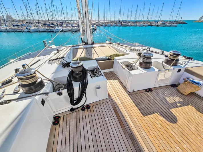 Firefly Yacht Photos Pics Deck of 2012 Lagoon 620 NEO yacht in marina, featuring winches and teak flooring.