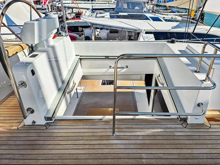 Firefly Yacht Photos Pics Lagoon 620 NEO 2012 yacht deck with stairs and railing, showcasing luxury design.
