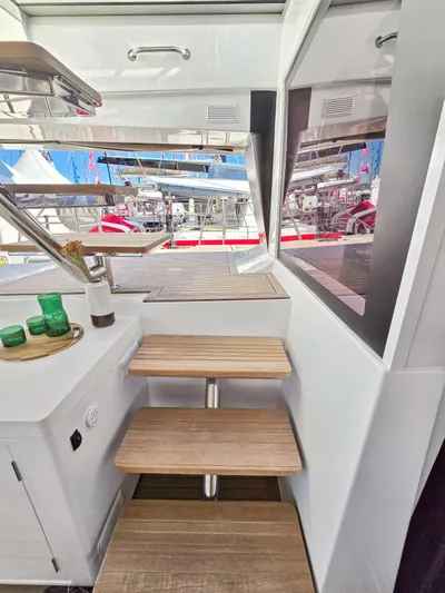 Firefly Yacht Photos Pics Interior view of 2012 Lagoon 620 NEO yacht with wooden steps and modern design.