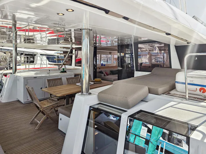 Firefly Yacht Photos Pics Luxurious Lagoon 620 NEO 2012 yacht interior with dining area and sunbathing deck.