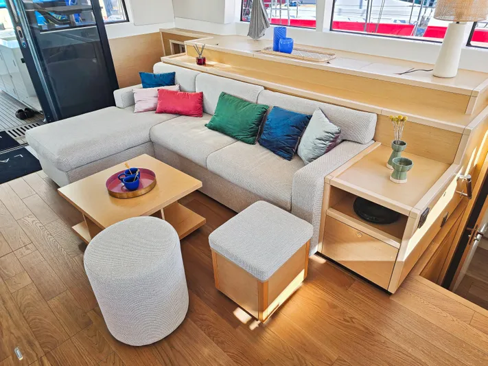 Firefly Yacht Photos Pics Luxurious Lagoon 620 NEO 2012 yacht interior with modern seating and colorful cushions.
