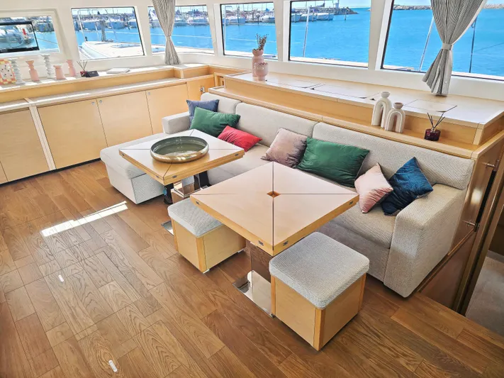 Firefly Yacht Photos Pics Luxurious interior of 2012 Lagoon 620 NEO yacht with elegant seating and ocean view.
