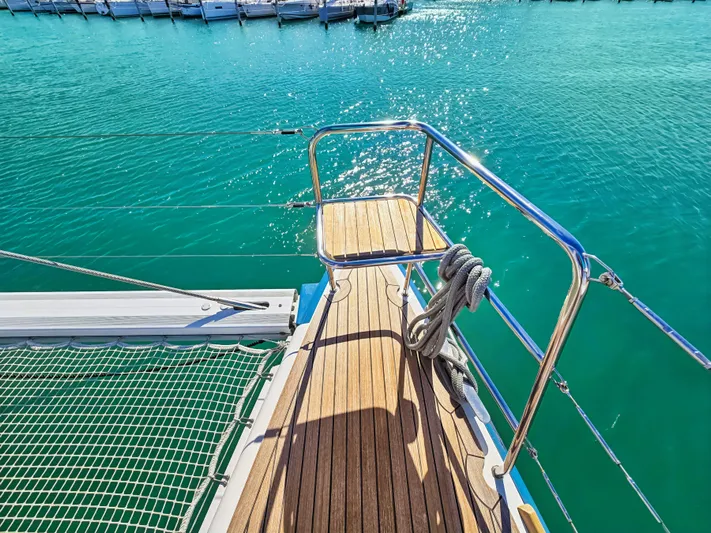 Firefly Yacht Photos Pics Deck of 2012 Lagoon 620 NEO yacht with turquoise water and docked boats.