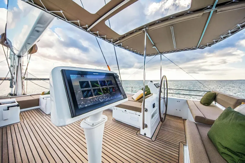 Firefly Yacht Photos Pics Luxurious Lagoon 620 NEO yacht deck with navigation system, ocean view, and comfortable seating.