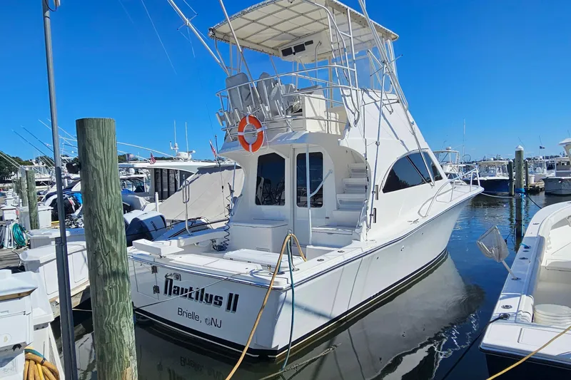  Yacht Photos Pics 2004 Luhrs 34 Convertible yacht docked at marina, featuring flybridge and sleek design.