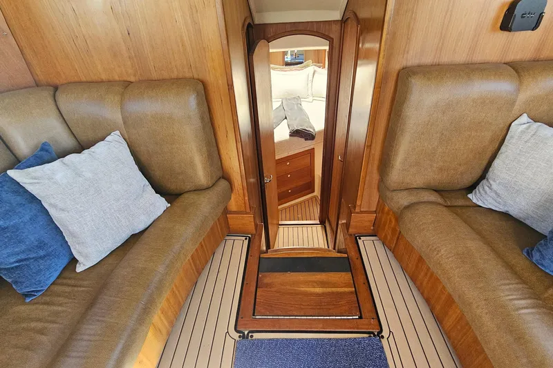  Yacht Photos Pics 2004 Luhrs 34 Convertible interior with cozy seating and elegant wood finish.
