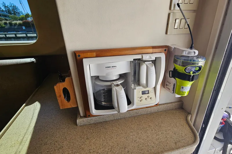  Yacht Photos Pics 2004 Luhrs 34 Convertible interior with mounted coffee maker and emergency equipment.