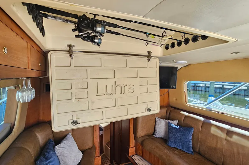  Yacht Photos Pics Interior of 2004 Luhrs 34 Convertible boat with fishing rods and cozy seating.