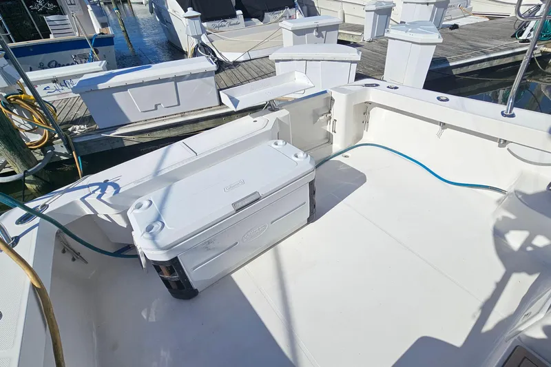  Yacht Photos Pics 2004 Luhrs 34 Convertible boat deck with storage and cooler, docked at marina.