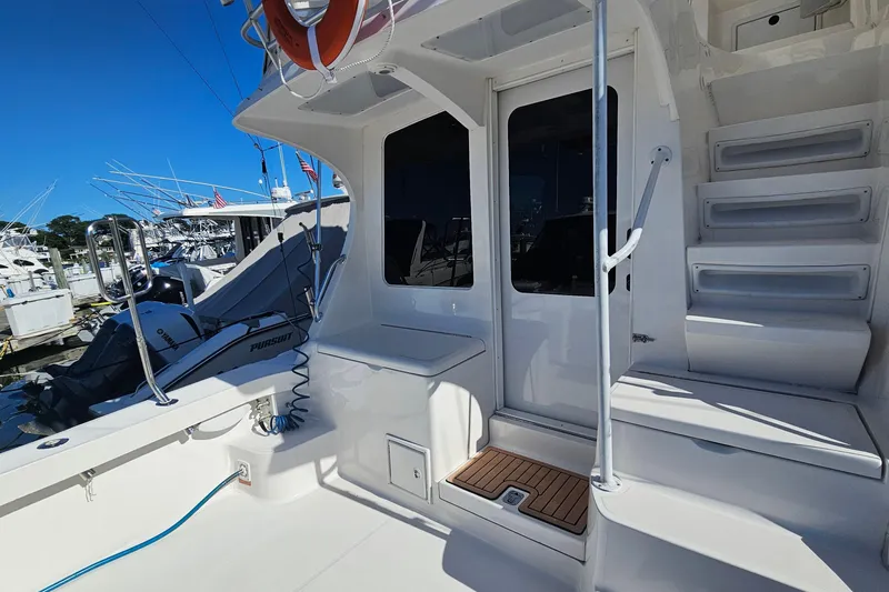  Yacht Photos Pics 2004 Luhrs 34 Convertible yacht deck with stairs and marina view.