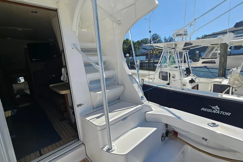  Yacht Photos Pics 2004 Luhrs 34 Convertible yacht interior with stairs and docked boats in marina.