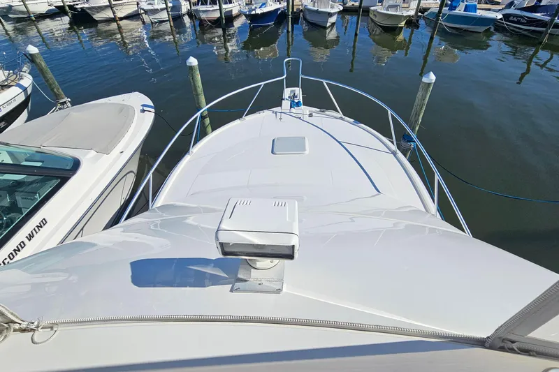  Yacht Photos Pics 2004 Luhrs 34 Convertible yacht docked at marina, view from bow.