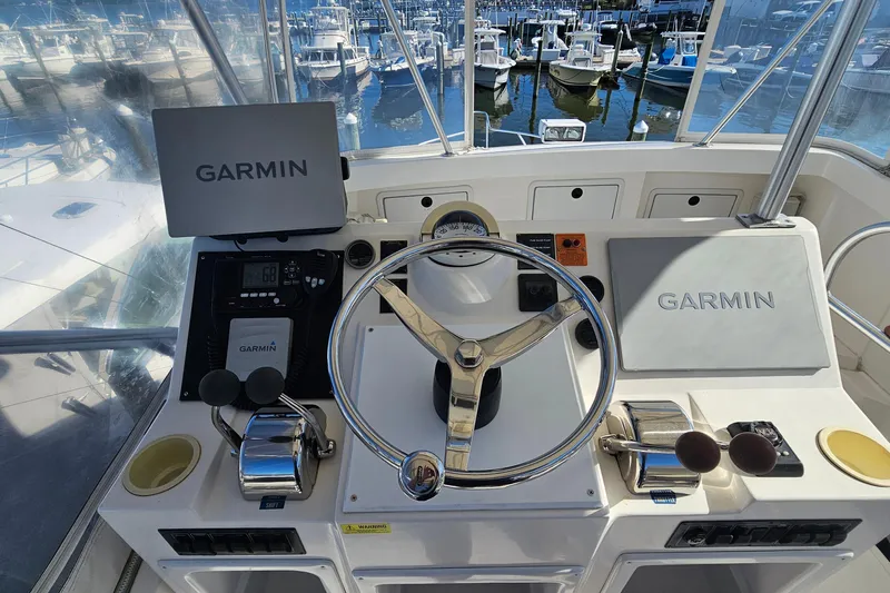  Yacht Photos Pics Helm of 2004 Luhrs 34 Convertible with Garmin navigation, marina view in background.