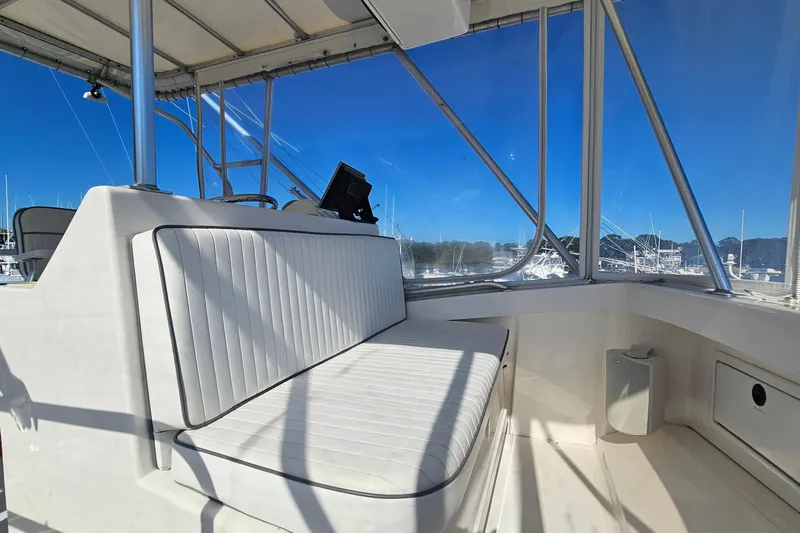  Yacht Photos Pics 2004 Luhrs 34 Convertible boat interior with cushioned seating and clear windows.