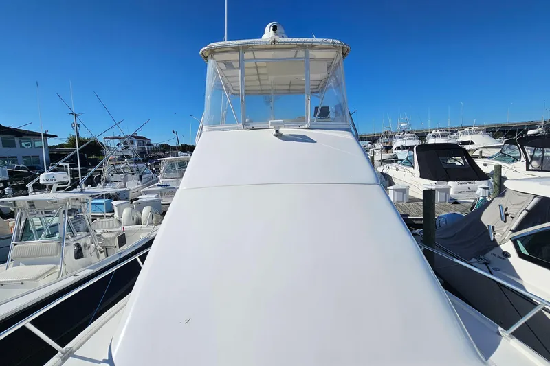  Yacht Photos Pics 2004 Luhrs 34 Convertible yacht docked in a marina under clear blue skies.