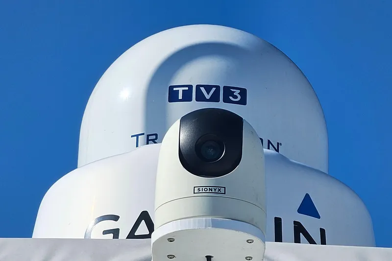  Yacht Photos Pics Radar and camera equipment on a 2004 Luhrs 34 Convertible boat against a clear blue sky.