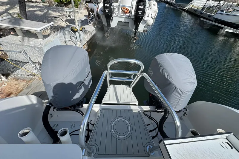  Yacht Photos Pics 2019 World Cat 295 CC boat with covered engines docked at marina.