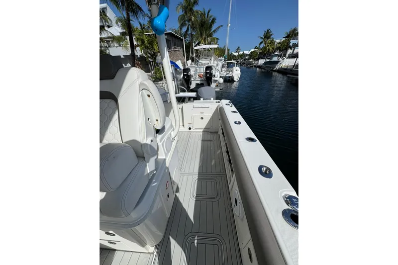  Yacht Photos Pics 2019 World Cat 295 CC boat interior with seating, docked in a sunny marina.