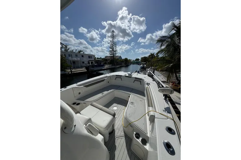  Yacht Photos Pics 2019 World Cat 295 CC boat docked under a sunny sky with palm trees.