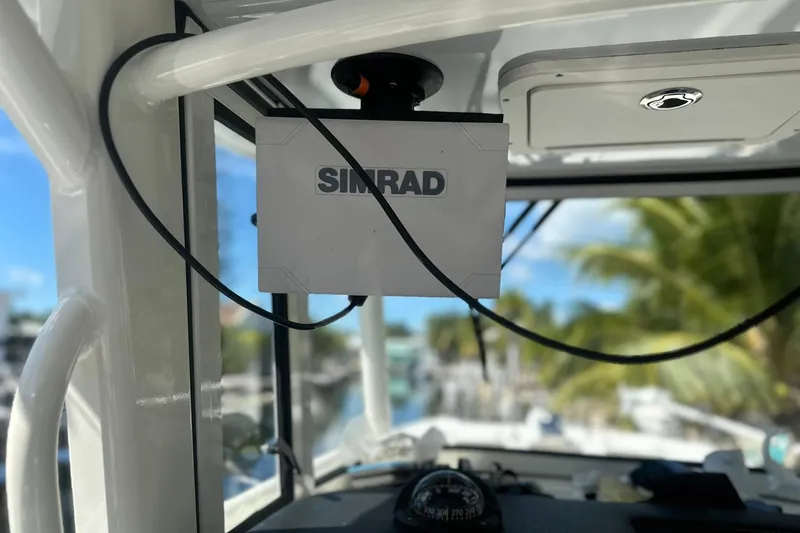  Yacht Photos Pics Simrad navigation system on 2021 World Cat 295 CC boat, with tropical background.