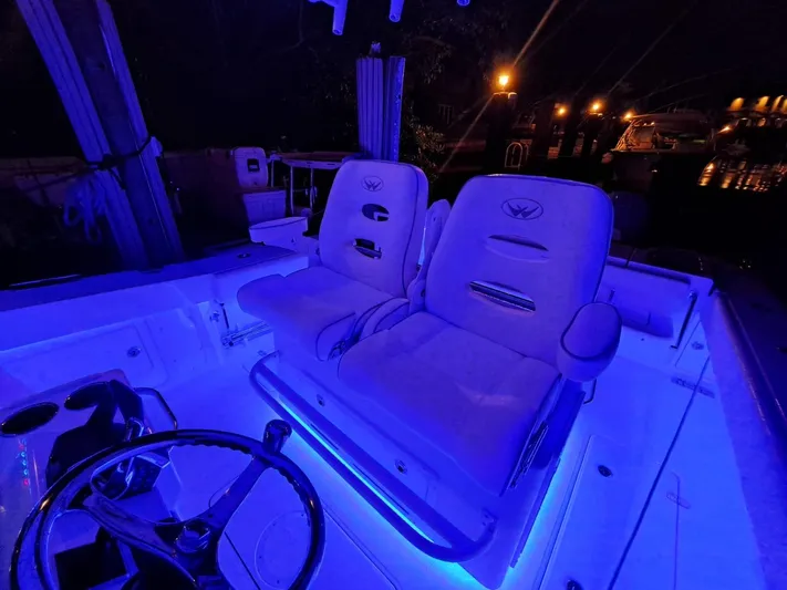  Yacht Photos Pics 2024 Southport 30 FE boat interior with illuminated captain's chairs at night.